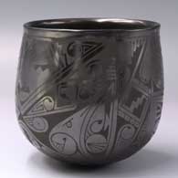 A black-on-black jar with a geometric design