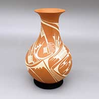 A red-on-red jar with a tall recurved neck and a painted geometric design