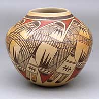 A polychrome jar decorated with a stylized migration pattern design