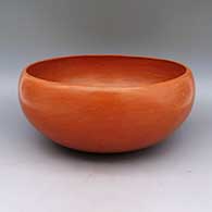 A plain highly polished red bowl