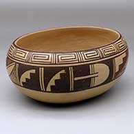 An oval polychrome bowl polished inside and decorated with a band of geometric design around the body