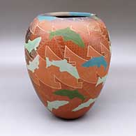 A large polychrome jar with an asymmetrical opening, fire clouds, and a sgraffito and painted fish and geometric design
