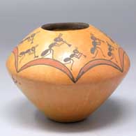 A polychrome bowl decorated with a rainbow and kokopelli design above the shoulder