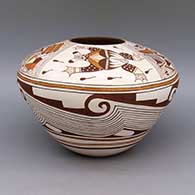 A polychrome jar decorated with frog, tadpole, moon, star, broken shard, geometric design, and micaceous slip details