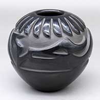 A black jar carved with an avanyu, band-of-feathers and geometric design