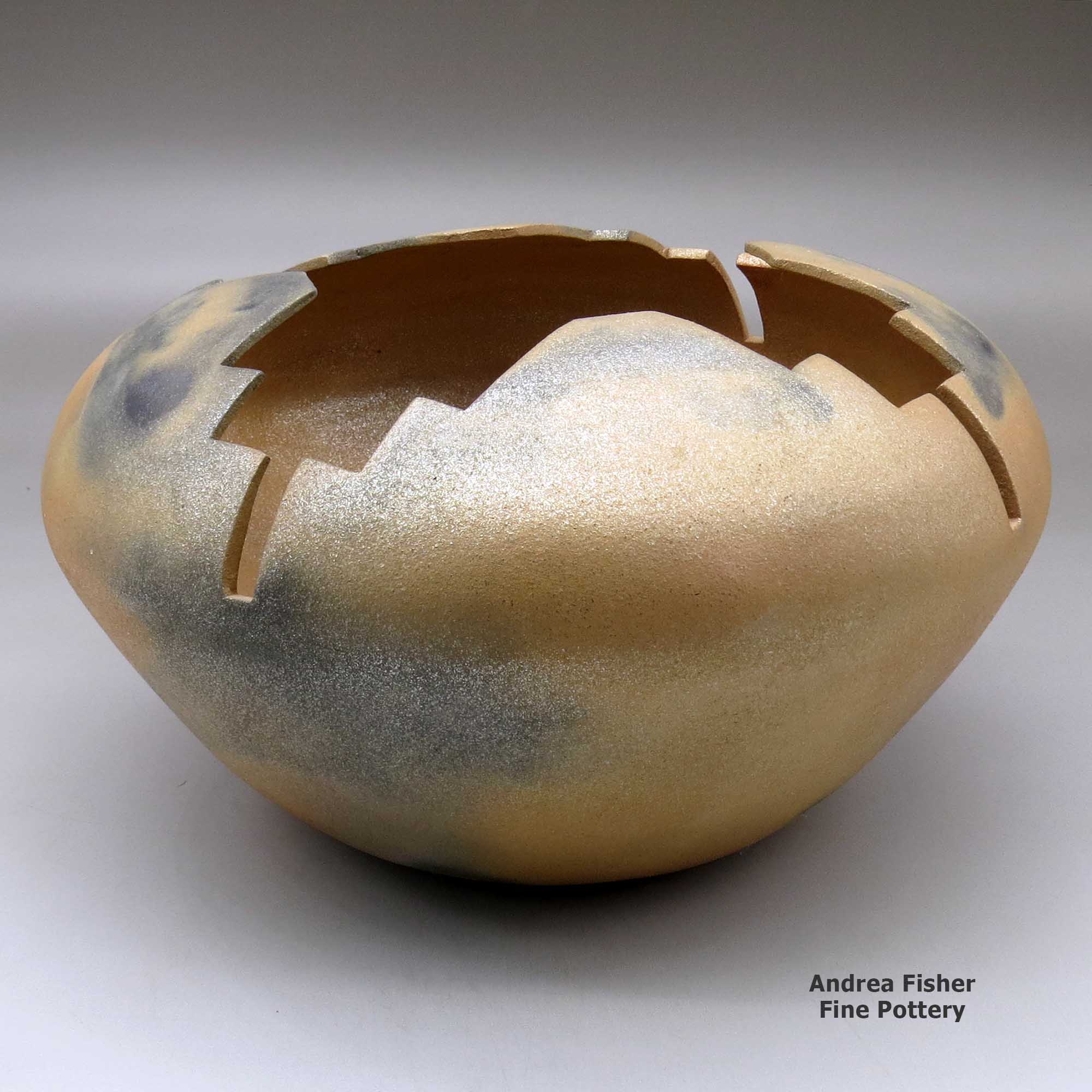 Click or tap to see a larger view A large golden micaceous prayer jar with fire clouds and a geometric carved opening made by Angie Yazzie of Taos