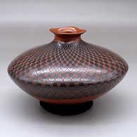 A black on red seed pot with a short neck and square rim, decorated with a checkerboard geometric design
 by Yoly Ledezma of Mata Ortiz and Casas Grandes