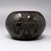 Black jar with carved bird design, click or tap to see a larger version