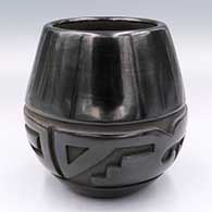 Black jar carved with a 2-panel stylized avanyu design
 by LuAnn Tafoya of Santa Clara