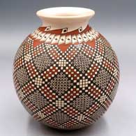 Polychrome jar with a rolled lip and a spiral cuadrillos and geometric design
 by Alma Flores of Mata Ortiz and Casas Grandes