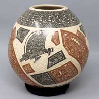 A polychrome jar decorated with a sgraffito and slipped bird, lizard and geometric design
 by Juan Carlos Rodriguez of Mata Ortiz and Casas Grandes