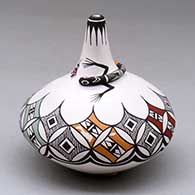 A polychrome low shouldered jar with a thin neck decorated with a lizard applique around the base of the neck and painted with a geometric design around the shoulder
 by Carolyn Concho of Acoma