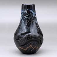 A polychrome vase carved with an avanyu design and decorated with a sgraffito and painted masked Hopi dancer and geometric design, click or tap to see a larger version