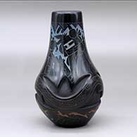 A polychrome vase carved with an avanyu design and decorated with a sgraffito and painted masked Hopi dancer and geometric design, click or tap to see a larger version