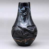 A polychrome vase carved with an avanyu design and decorated with a sgraffito and painted masked Hopi dancer and geometric design, click or tap to see a larger version