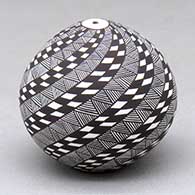 Click for a larger view A miniature black on white seed pot decorated with a spiraling checkerboard and fineline design
by Sharon Lewis of Acoma