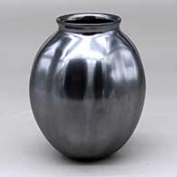 A glossy black melon jar with eight repousse ribs and a flared rim
 by Jose Marin of Mata Ortiz and Casas Grandes