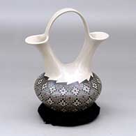 A small polychrome wedding vase decorated with a tiny squares and geometric design
 by Jesus Olivas of Mata Ortiz and Casas Grandes