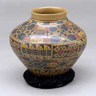 A polychrome jar decorated around the body with bands of geometric design
 by Gerardo Pedregon of Mata Ortiz and Casas Grandes