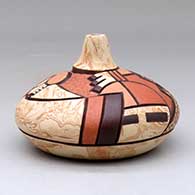 A polychrome seed pot decorated with a carved, sgraffito and painted pueblo dancer and geometric design, click or tap to see a larger version