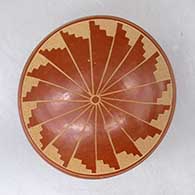 A red seed pot decorated with a geometric design above the shoulder
 by Brenda Tafoya of Jemez