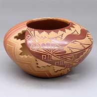 A polychrome jar decorated with carved melon ribs, cutouts and a sgraffito avanyu and geometric design
 by Vangie Tafoya of Jemez
