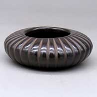 A low black carved melon jar with 32 ribs
 by David Baca of Santa Clara
