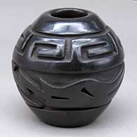 A small black jar carved around the body with an avanyu design and around the neck with a band of feathers design
 by Jennifer Naranjo of Santa Clara