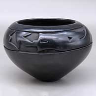 A high shouldered black bowl carved above the shoulder with an avanyu and geometric design
 by Mida Tafoya of Santa Clara