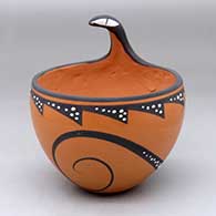 Click for a larger view A polychrome bowl decorated with a lizard applique on the rim and painted with a lizard and geometric design around the body
by Anderson Peynetsa of Zuni