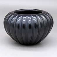 A black melon bowl with 24 carved ribs
 by Angela Baca of Santa Clara