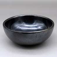 A plain black bowl polished inside and out
 by Maria Martinez of San Ildefonso