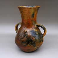 Large red jar with a pine pitch coating, a flared opening, handles, fire clouds, and an applique horned lizard design
 by Elizabeth Manygoats of Dineh