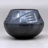 A black on black jar decorated with a four panel bat wing and geometric design above the shoulder, click or tap to see a larger version