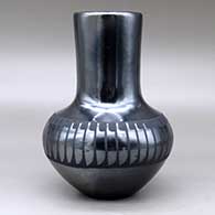 A black on black vase decorated around the shoulder with a band of feathers design, click or tap to see a larger version