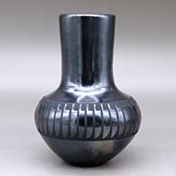 A black on black vase decorated around the shoulder with a band of feathers design, click or tap to see a larger version