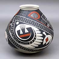 A jar with a flared rim and decorated with a three panel geometric design
 by Juan Quezada Sr of Mata Ortiz and Casas Grandes