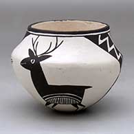 A black on white jar decorated with a four panel deer, lightning bolt and geometric design
 by Lucy Lewis of Acoma