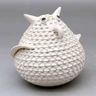 A black on white corrugated owl figure
 by Stella Shutiva of Acoma