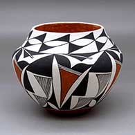 A polychrome jar decorated with a six panel fineline, kiva step and geometric design
 by Edna Chino of Acoma