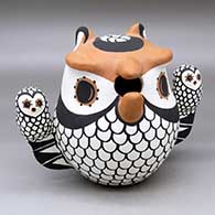 A polychrome owl storyteller figure with two chicks
 by Mary Garcia of Acoma