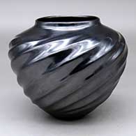 A black melon jar with 14 repousse ribs
 by Alonso Sandoval of Mata Ortiz and Casas Grandes