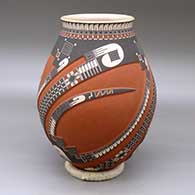 A polychrome jar with a flared lip and decorated with a three panel carved and painted sickle, feather and geometric design
 by Tavo Silveira of Mata Ortiz and Casas Grandes