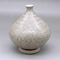 A tiny necked jar decorated with a fineline and geometric design
 by Oralia Lopez of Mata Ortiz and Casas Grandes