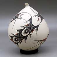 A polychrome seed pot with a sculpted opening and decorated in the Quezada style with a flowing geometric design, click or tap to see a larger version