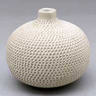A small corrugated buff jar with a small raised squarish neck
 by Fito Tena of Mata Ortiz and Casas Grandes