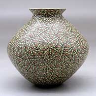 A small polychrome jar with a flared lip and decorated with a tiny lines and rectangles geometric design, click or tap to see a larger version