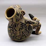 A backward leaning sitting shaman figure holding a knife, a bowl with ears of corn and with a metate between his feet, click or tap to see a larger version