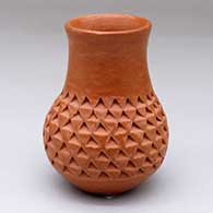 A small red jar with a corrugated surface below the neck
 by Garnet Pavatea of Hopi