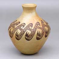 A brown-on-yellow thin neck jar decorated with a band of stylized migration pattern design around the shoulder
 by Neva Nampeyo of Hopi